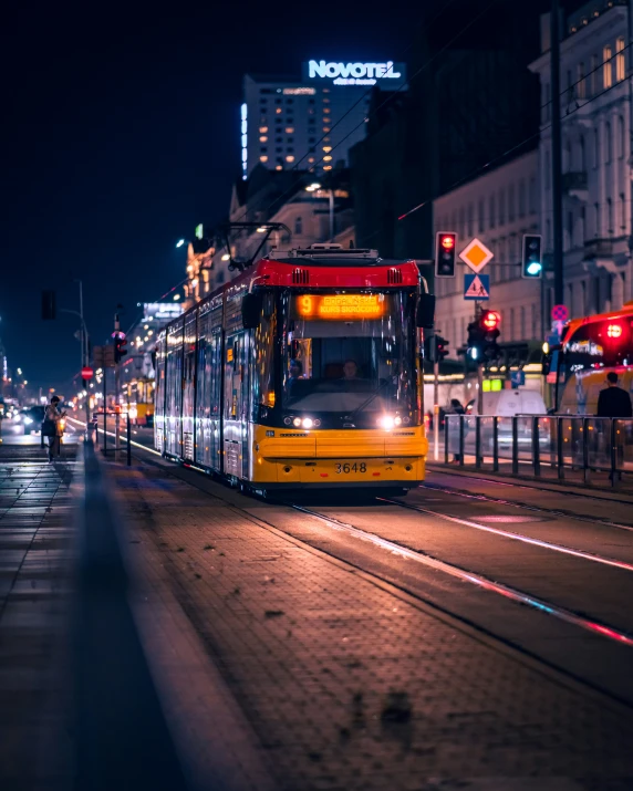 a street with a yellow trolley parked next to it