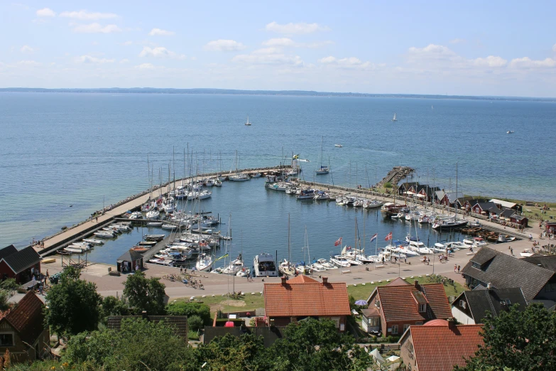 a harbor full of boats sitting next to a city on the ocean