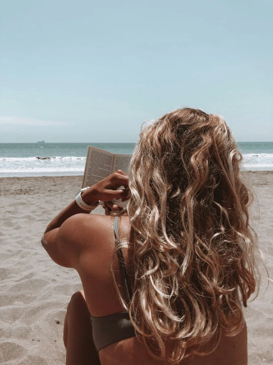 there is a woman with blond hair looking into the ocean