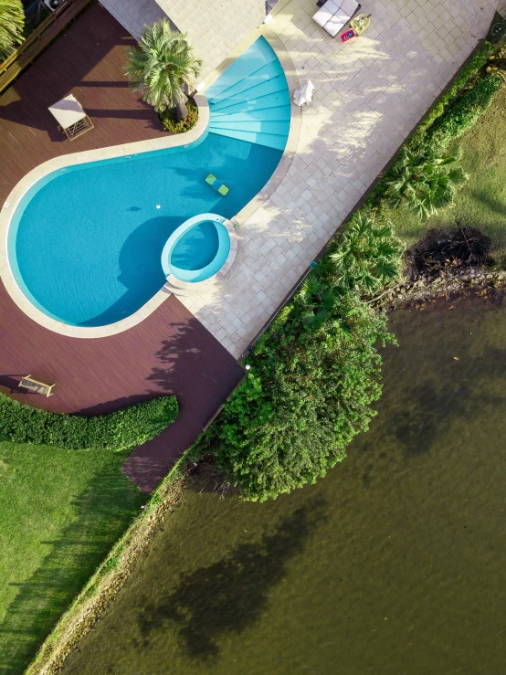 aerial view of pool in middle of landscaped area