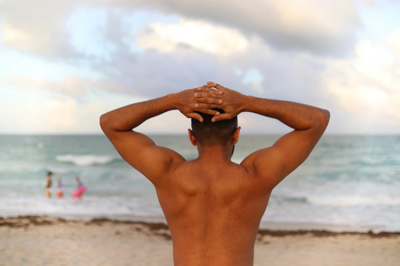 the man with  is on the beach near the water