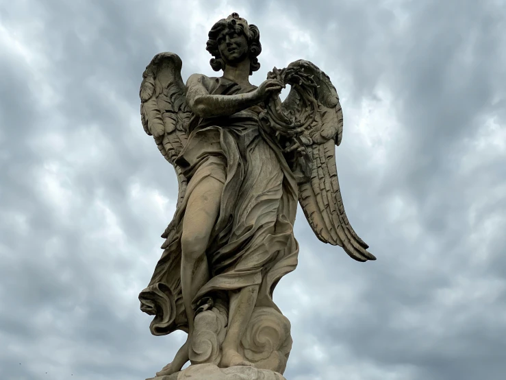 a stone angel is shown with its wings spread