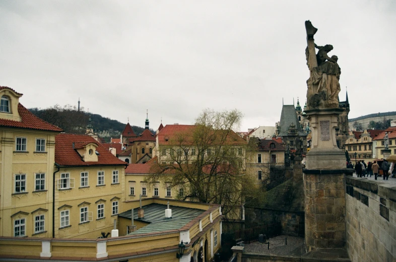 a statue is standing on top of a tall building