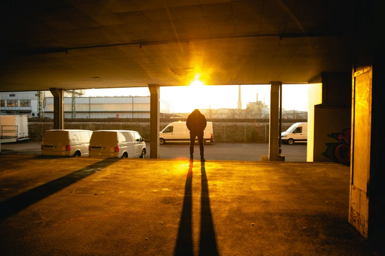 parking spaces with car parked under a bridge at sunset