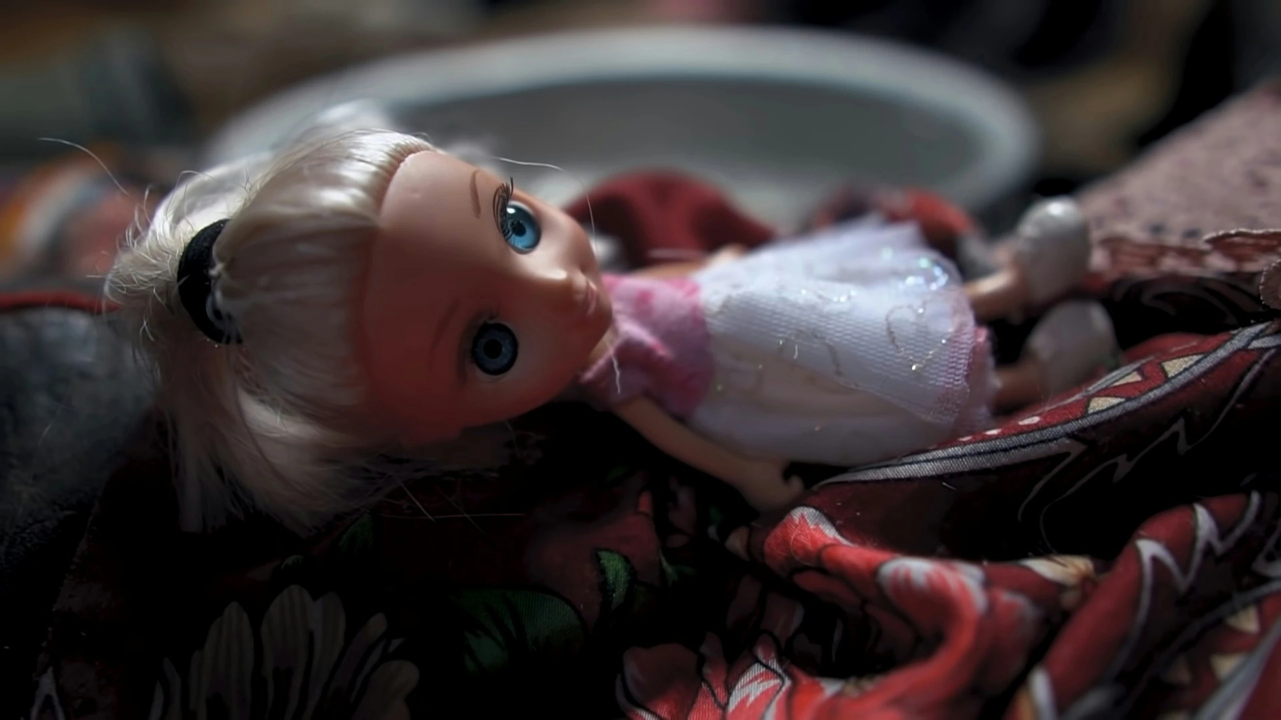 a close up of a doll with a very big eye