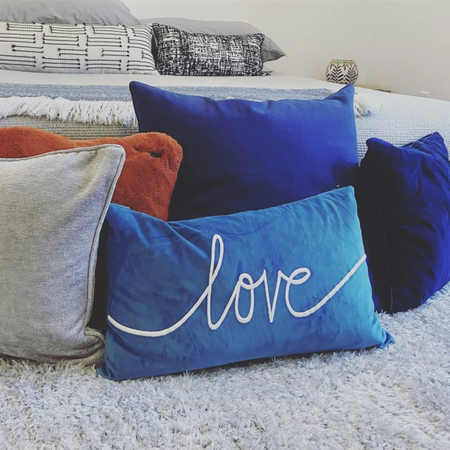 pillows on top of the bed with words written on them