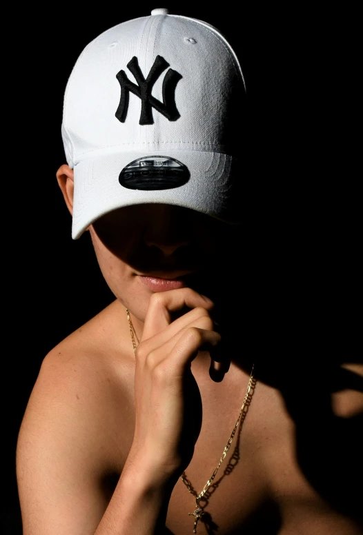 a person wearing a baseball cap with the word ny on it