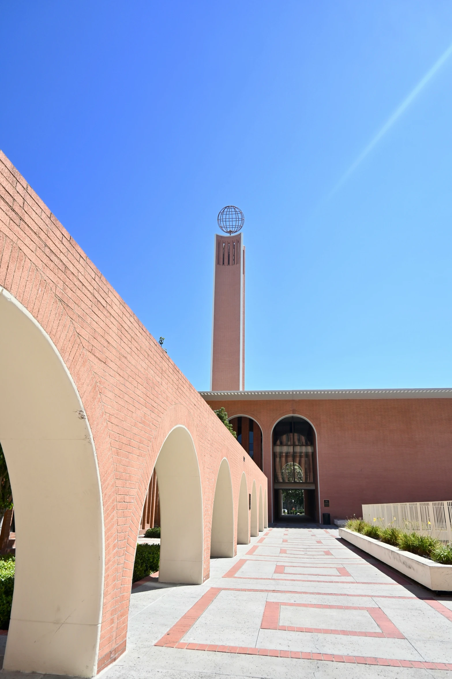 the outside courtyard of an office building with a clock tower on it