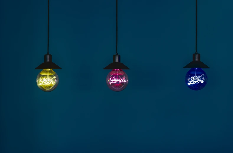 three light bulbs with different colored lights on them