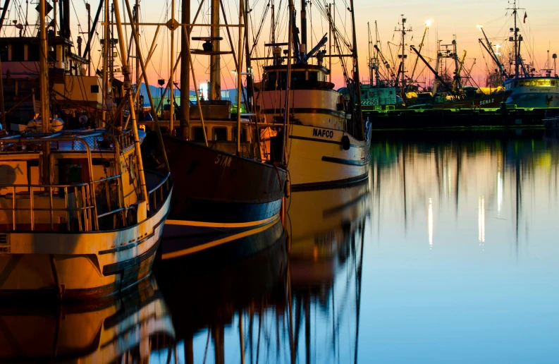 boats are parked in the dock next to the water