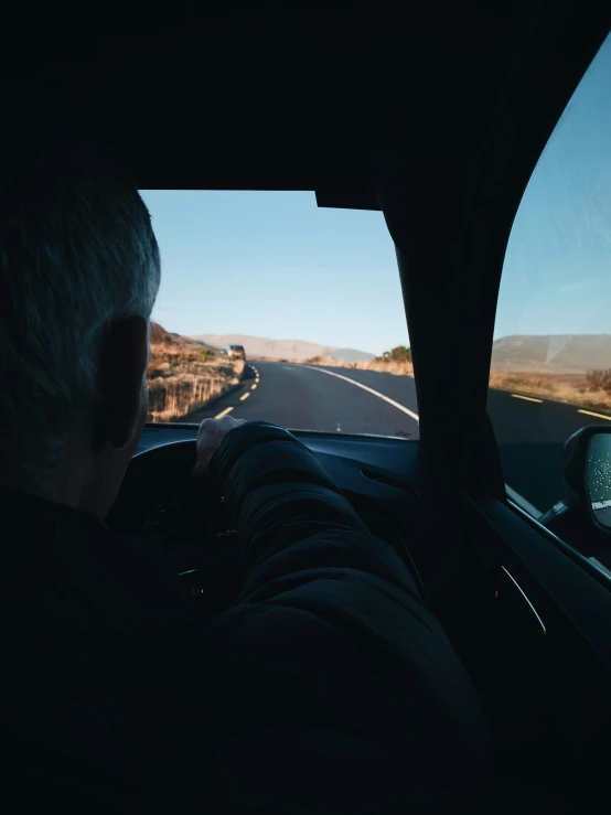 a driver looking at an open road at dusk