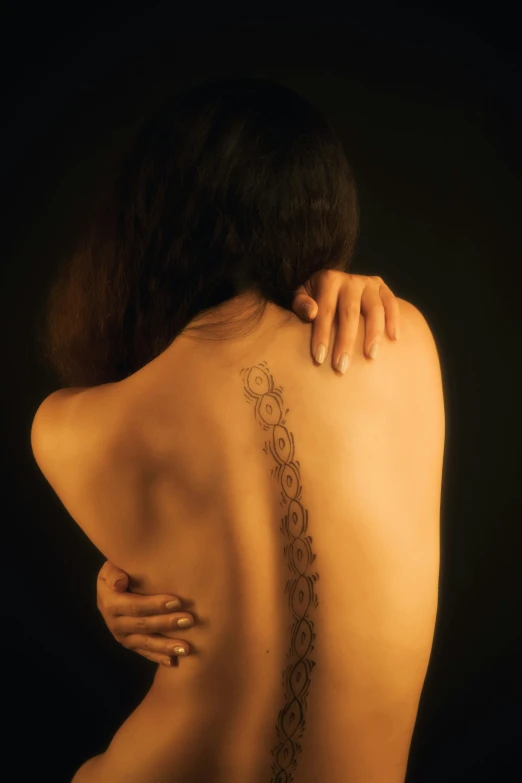 a tattoo that is on the back of a woman