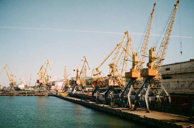 there are many cranes at the dock at this time