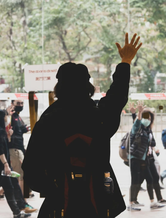 someone with their arms in the air watching others skateboarding