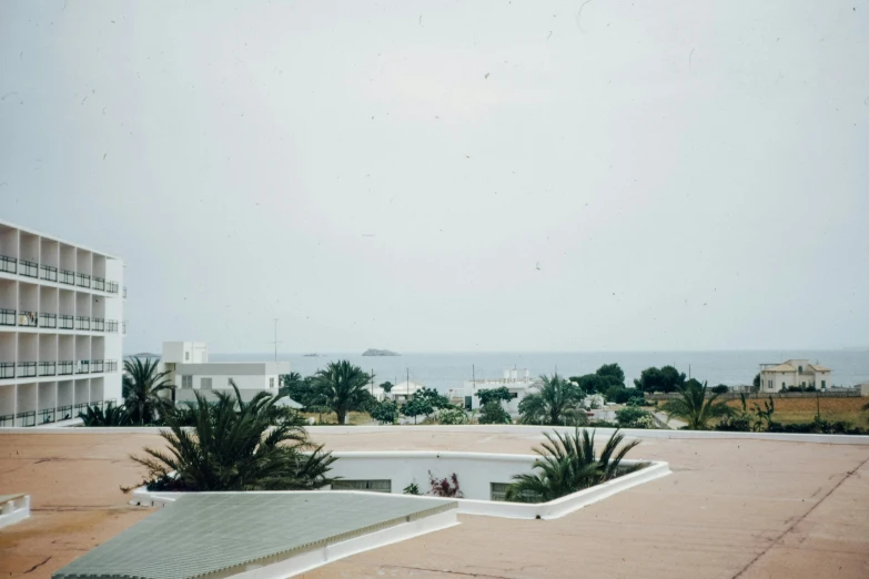 a view from the top of an apartment complex with the ocean in the background