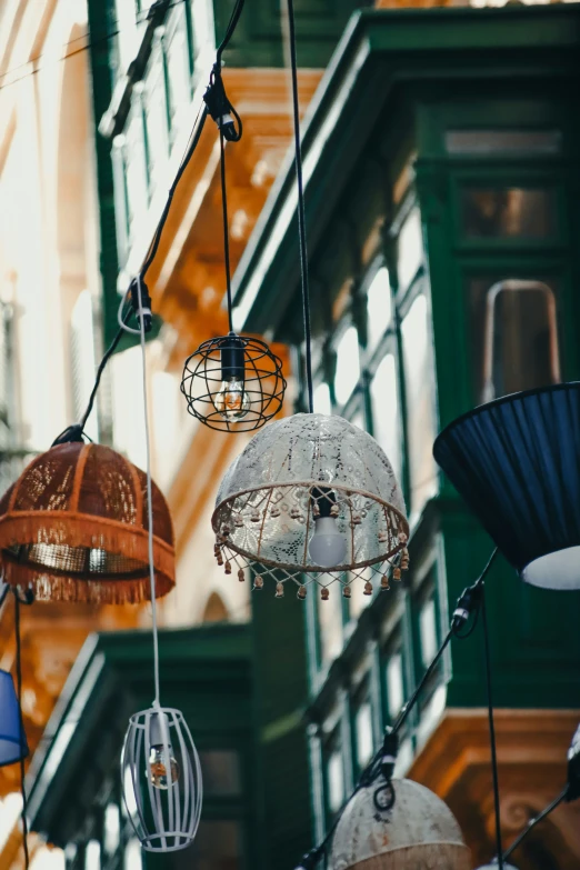 several different colored lamps hanging from a string