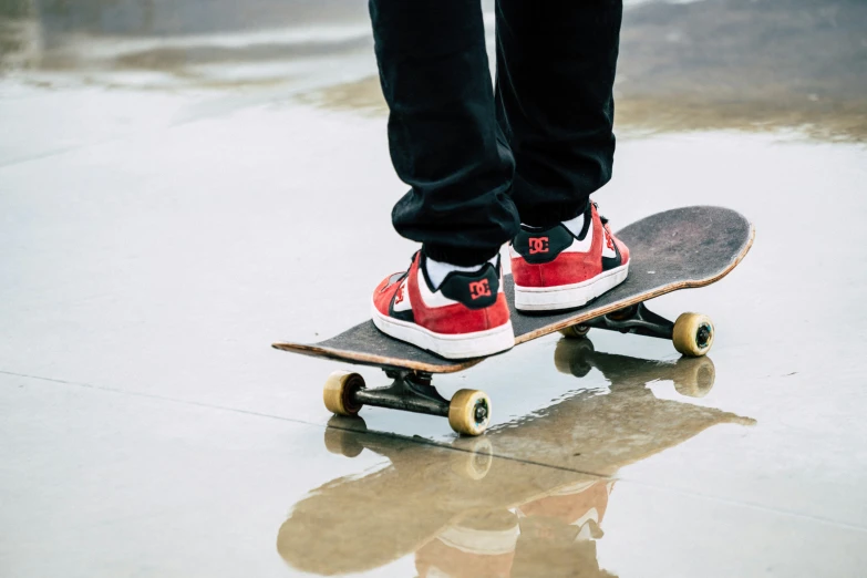 a skateboard with red and white shoes on the back
