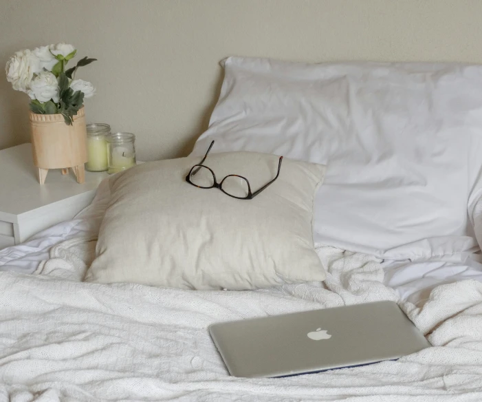 a laptop is sitting on top of a blanket