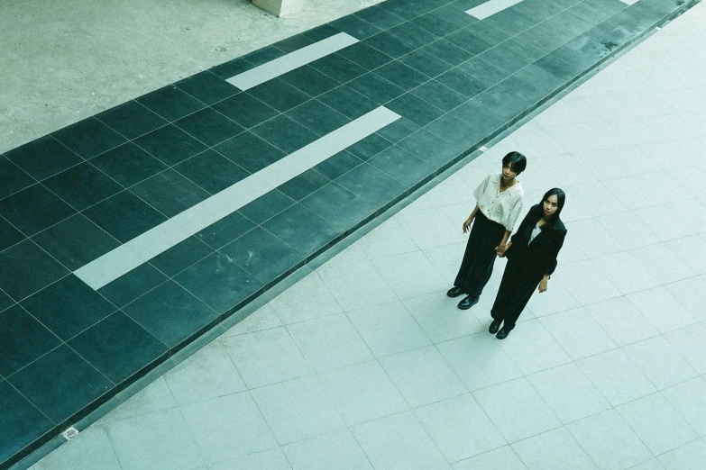 the couple is standing close to each other looking up