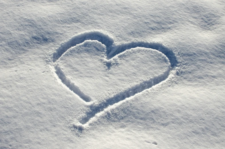 a heart shape made with the snow on the ground