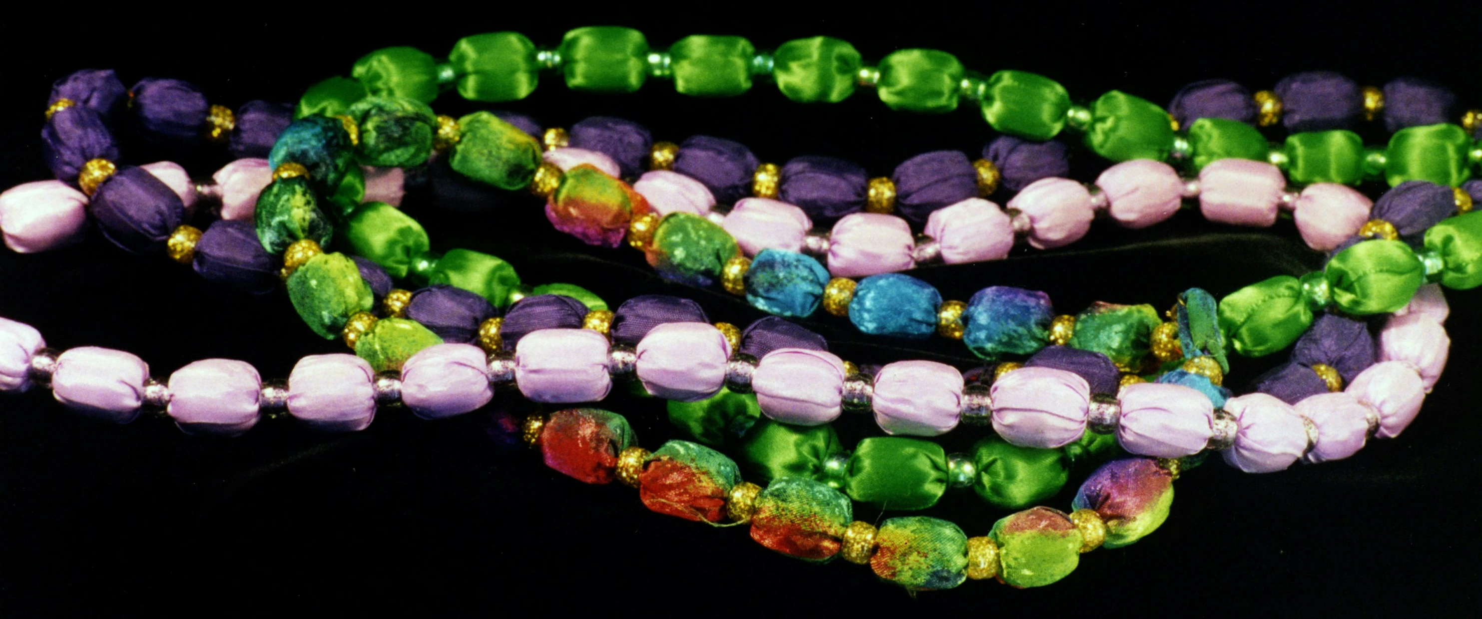 a set of four necklaces in various colors