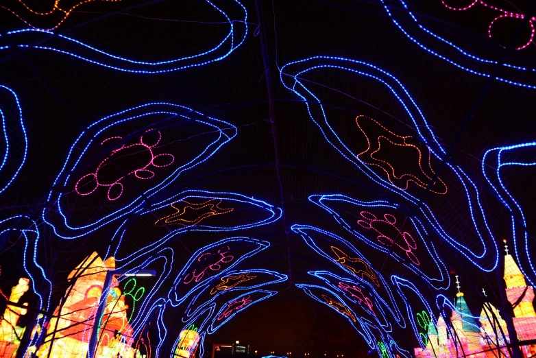 a long tunnel of lights is lit up at night