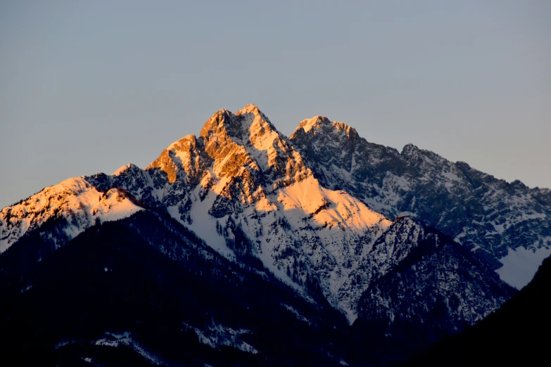 the mountains are tall, white and brown