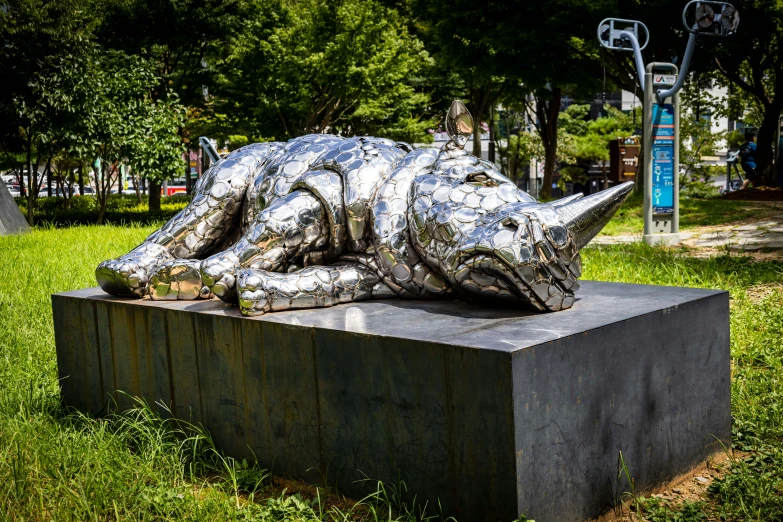 there is a sculpture on top of a concrete block