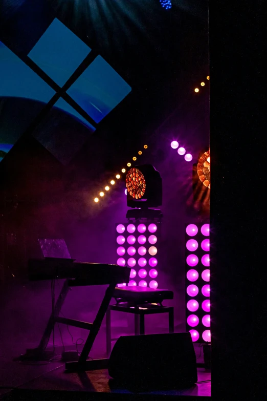 a keyboard and chair in front of bright colored wall