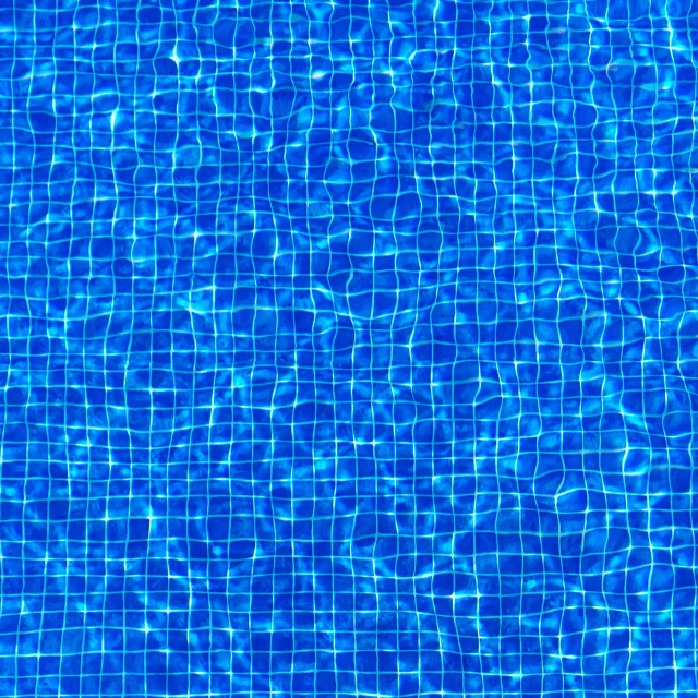 a blue swimming pool is in the middle of it