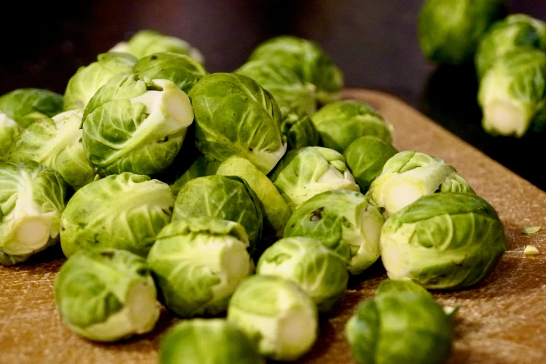 chopped brussel sprouts are sitting on a  board