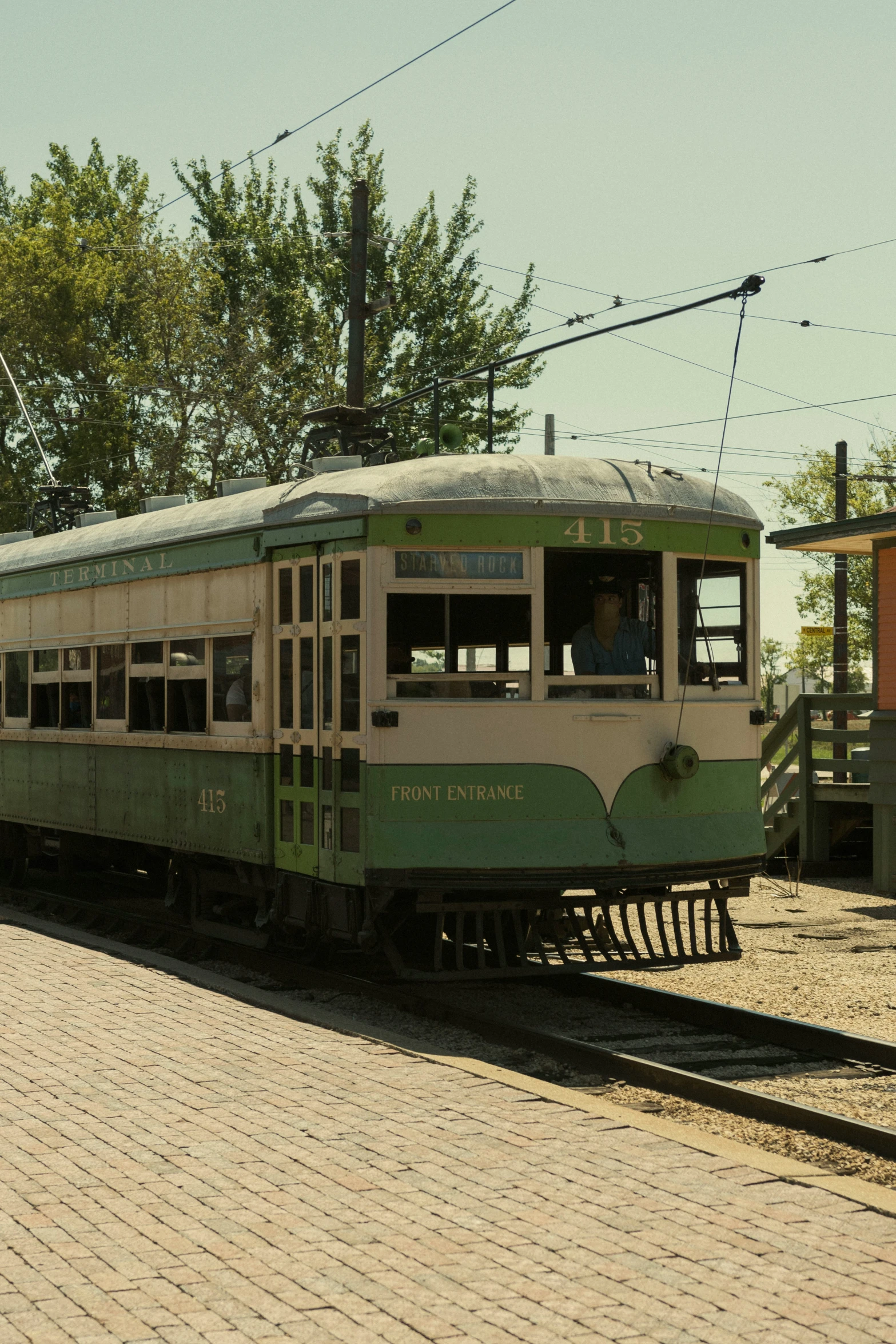 an old style train with a few people inside