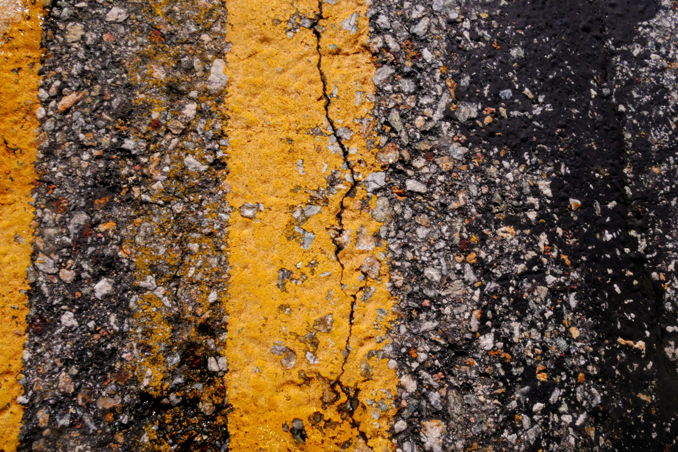 the street in front of the pavement has yellow stripes