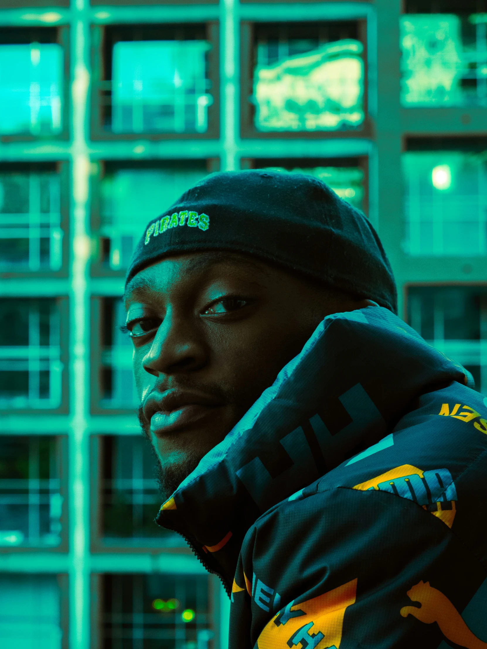 a black man wearing a hat and jacket