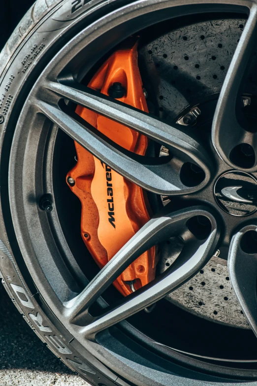 a close up image of a sports car wheel