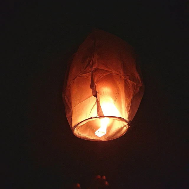 a lit lantern hanging from the ceiling