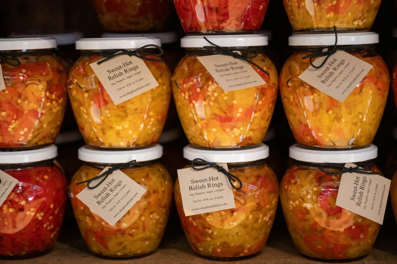 jars of pickled fruits are labeled with information