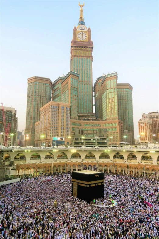 large group of people gathering together around the kabab in the middle of a city