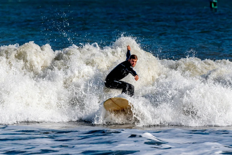 the man is riding the waves in the ocean