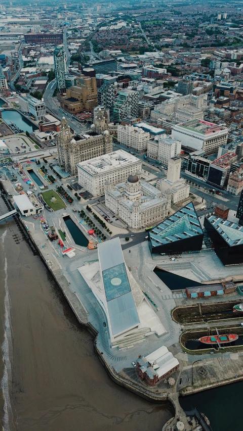 an aerial view of cityscapes next to river and town