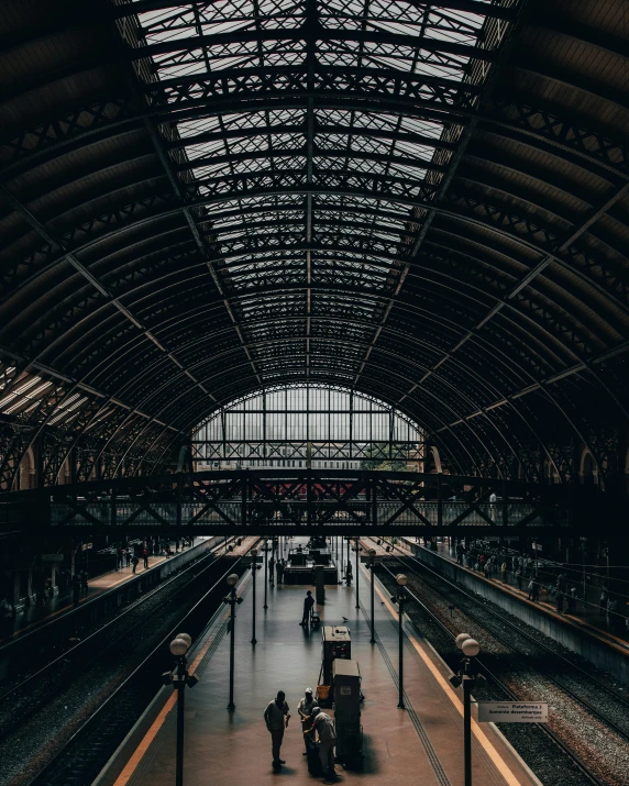 people stand in the train station while others look on