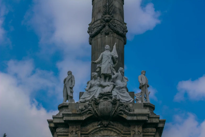 a very ornate clock tower with statues on it