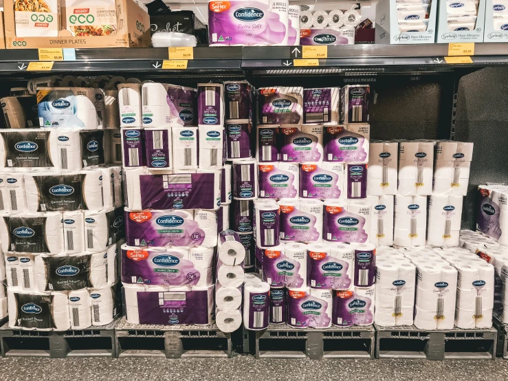 bundles of toilet rolls are stacked on the shelf