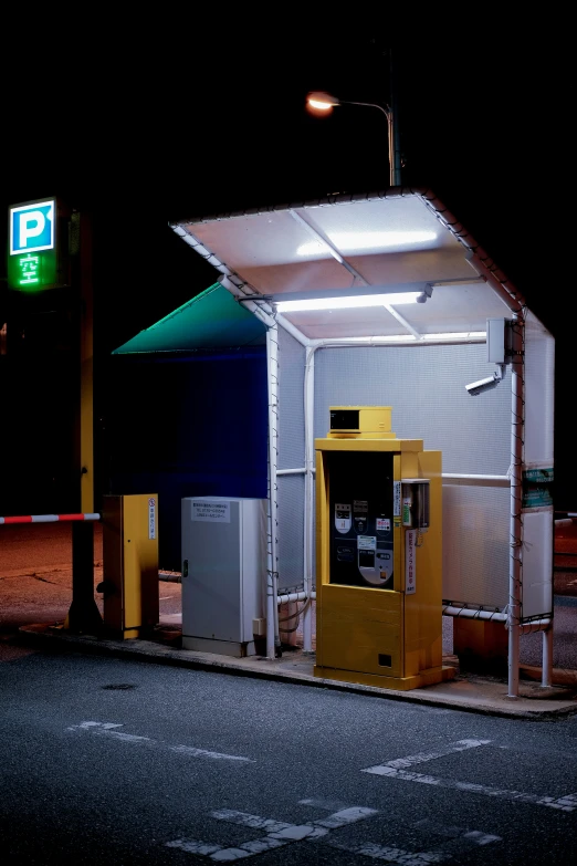 an automatic gas pump at the night in an empty lot