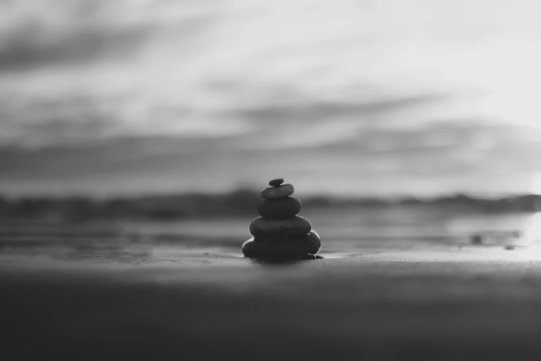 a stack of rocks sitting on top of a sandy beach