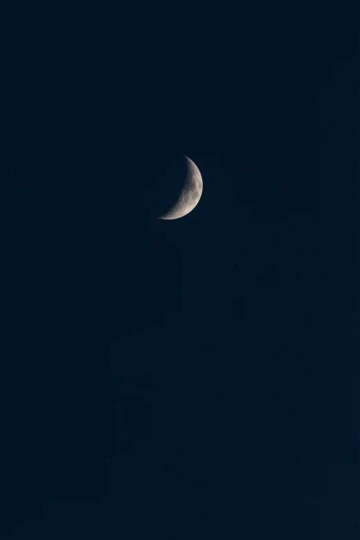 the moon appears to be partially obscured by a cloudless night sky