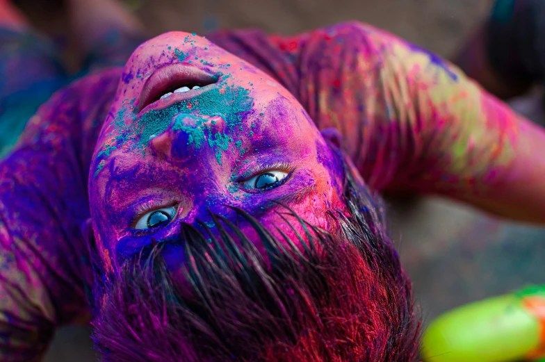 an aerial s of a woman's face covered in colors