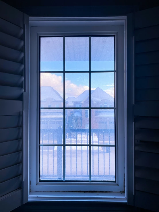 a window with a view of some mountains