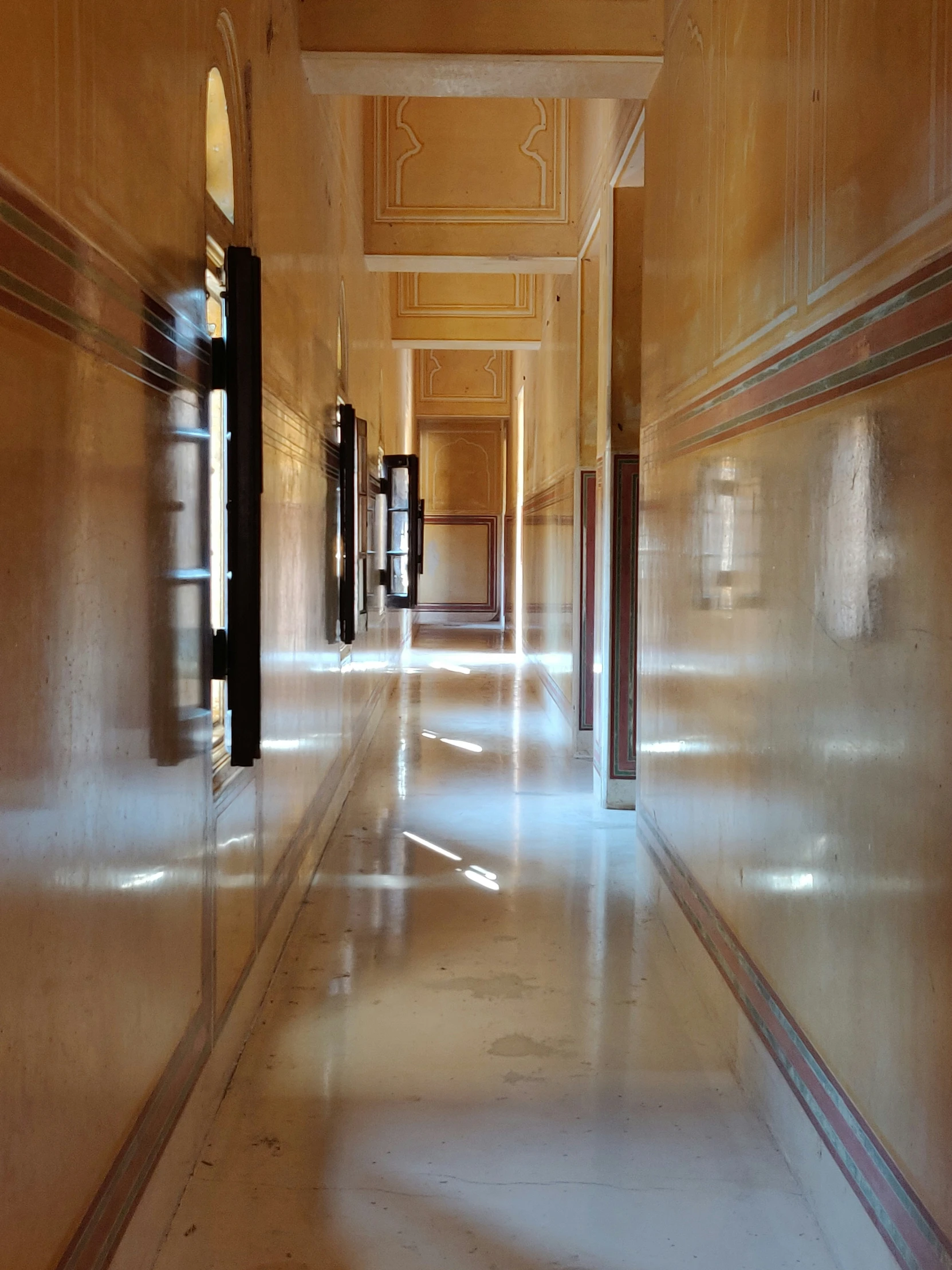 a long hallway with multiple telephones in the room