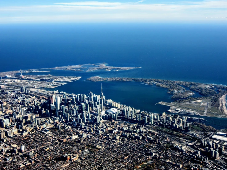 a city and lake with blue sky in the background